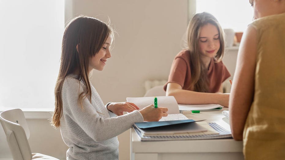 little girl working with her mom