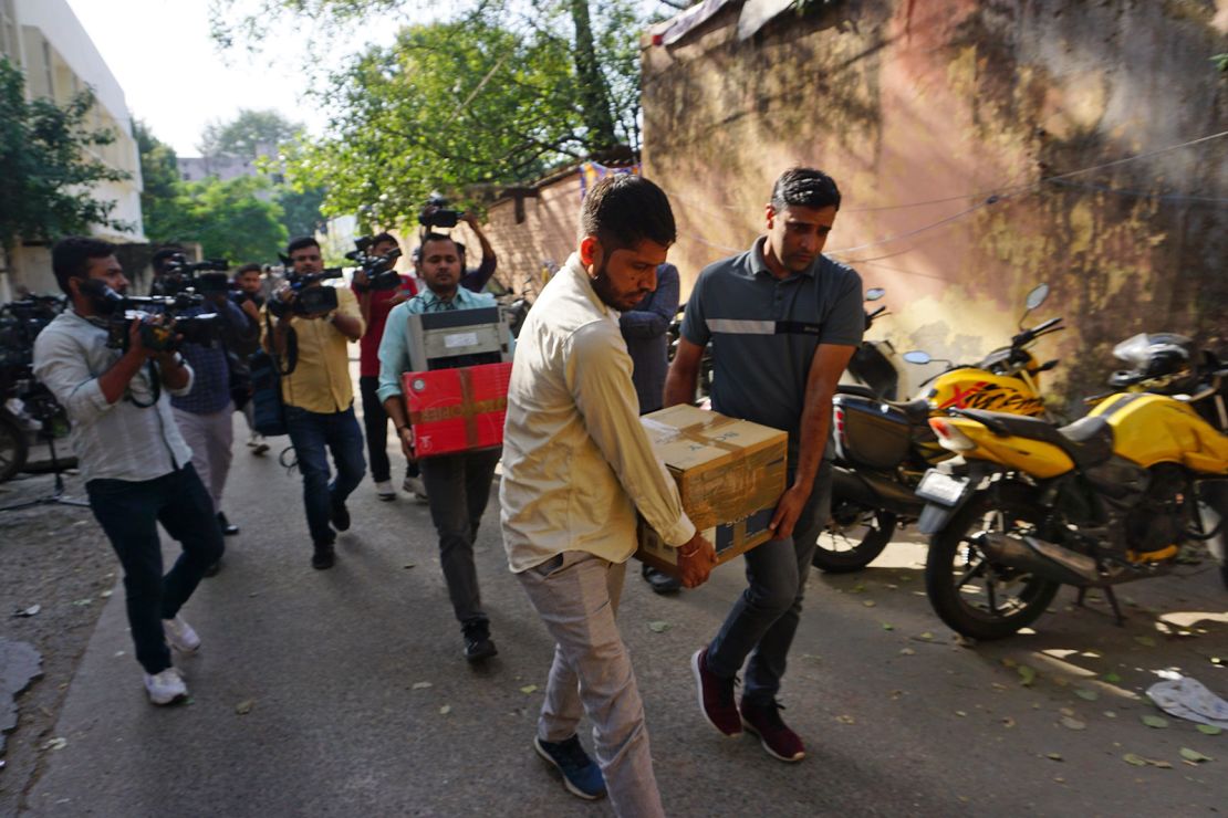 Security officers after a raid at the office of NewsClick in New Delhi, India, Tuesday, Oct. 3, 2023.