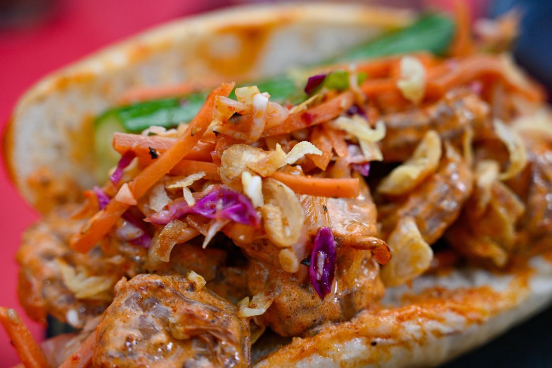 Gochugaru-marinated shrimp on a potato roll with kimchi slaw, gochujang mayonnaise and spicy pickle spear available at Sonoma Terrace during Lunar New Year at Disney California Adventure in Anaheim, California.